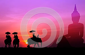Silhouette elephant with tourist with big buddha and pagada back