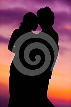 Silhouette of Embracing Asian Bride and Groom at Sunset