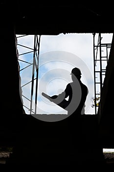 Silhouette of Engineer Architect working at Construction Site