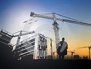 Silhouette engineer in a building site over Blurred constructio