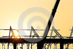 Silhouette engineer standing orders for construction crews to work on high ground heavy industry and safety