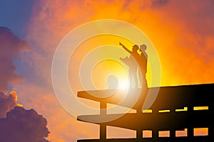Silhouette of Engineer and worker on building site, construction site with clipping path at sunset in evening time