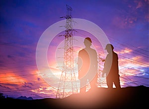 Silhouette engineer working in a building site over Blurred co