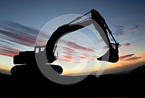 Silhouette of Excavator loader at construction site with raised