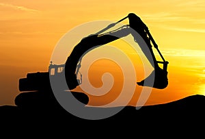 Silhouette of Excavator loader at construction site with raised