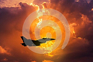 silhouette falcon fighter jet military aircraft flying on sunset photo