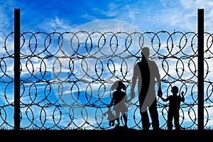 Silhouette of a family with children refugees photo
