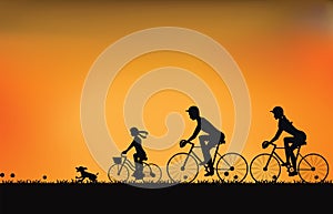 Silhouette of family driving bike with beautiful sky at sunset .