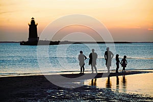 Silhouette of a family enjoying the sunset at Cape Henlopen State Park, Lewes, Delaware, U.S photo