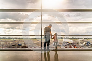 Silhouette of family, father and daughter on airport terminal