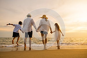 Silhouette of family holding hands live healthy lifestyle on beach