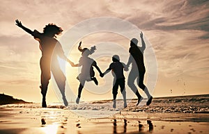 Silhouette, family jump on beach and sunset with ocean waves, back view and bonding in nature. Energy, people holding