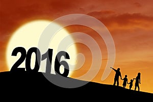 Silhouette family with numbers 2016 at hill