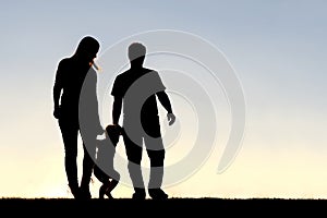 Silhouette of Family of Three People Walking at Sunset