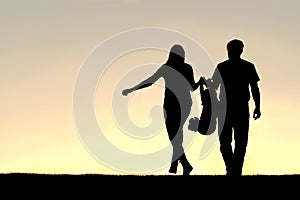 Silhouette of Family of Three People Walking at Sunset