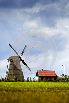 Silhouette of a farm , house and windmill.