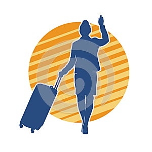 Silhouette of a fashionable female carrying a wheeled luggage travel bag. Silhouette of a business woman doing business trip