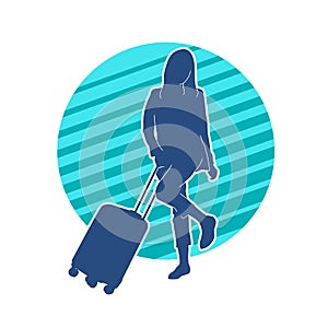 Silhouette of a fashionable female carrying a wheeled luggage travel bag. Silhouette of a business woman doing business trip