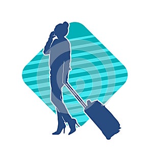 Silhouette of a fashionable female carrying a wheeled luggage travel bag. Silhouette of a business woman doing business trip