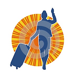 Silhouette of a fashionable female carrying a wheeled luggage travel bag. Silhouette of a business woman doing business trip