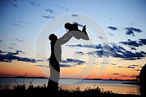 Silhouette of father and daughter in the sunset