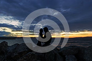 Silhouette of Father and son enjoying the sunset