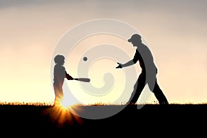 Silhouette of Father and Son Playing Baseball Outside