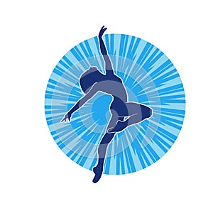 Silhouette of a female ballet dancer in action pose.