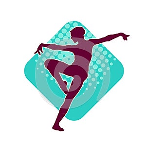 Silhouette of a female ballet dancer in action pose.