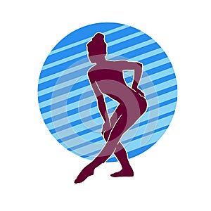 Silhouette of a female ballet dancer in action pose.