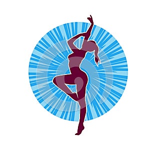 Silhouette of a female ballet dancer in action pose.