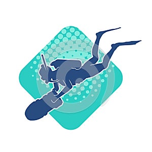 Silhouette of a female diver doing underwater observation with big torch