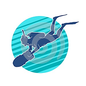 Silhouette of a female diver doing underwater observation with big torch