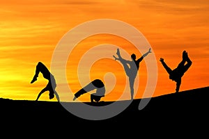 Silhouette of female gymnasts