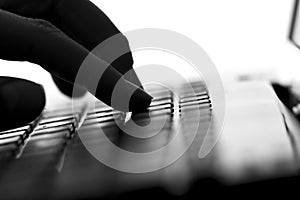 Silhouette of a female hands typing on the keyboard