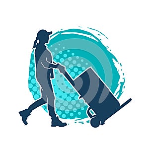 Silhouette of a female worker pushing lori wheels transporting carboard boxes.