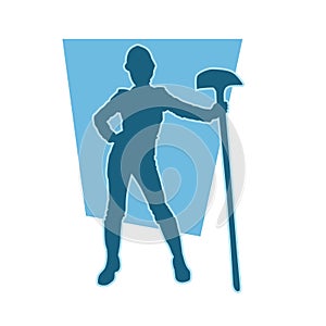 silhouette of a female worker standing pose with a shovel on her hand.