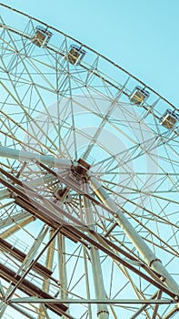 silhouette of Ferris wheel on the background of blue sky