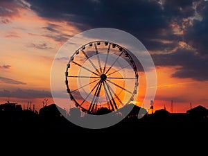 Silhouette of the ferris wheel at sunset