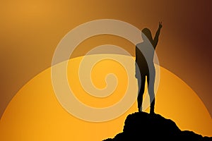 Silhouette of fighting woman at sunset or sunrise standing and raising up her hand and two finger in celebration.business success