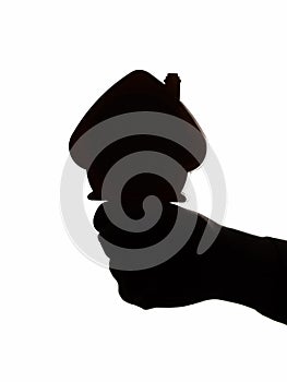 Silhouette figure of house on male hand fist , concept housing construction agency advertisement