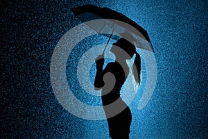 Silhouette of the figure of a young girl with an umbrella in the rain