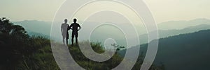 Silhouette Figures Overlooking Mountainous Landscape View