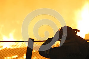 Silhouette of firefighter at a blaze