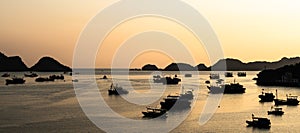 Silhouette of fisher boats and shore while sunset in Cat ba Island  Vietnam