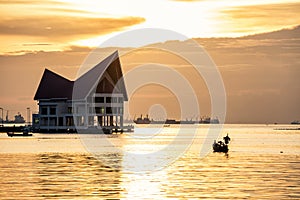 Silhouette fisherman on boat during sunset over a small island famous place of Chonburi Thailand called Koh-Loy