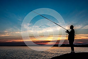 Silhouette Of A Fisherman With His Pole At The Atlantic Coast Of Wales, United Kingdom