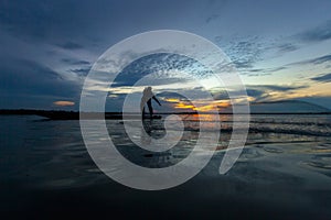 Silhouette fisherman with net at the lake