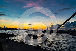 Silhouette of fisherman port of Hanga Roa Village at sunset in Easter Island