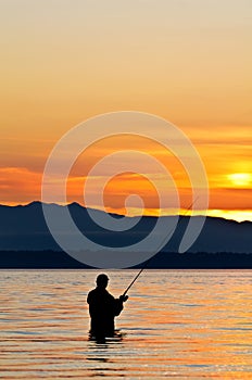 Silhouette of a fisherman at sunset.